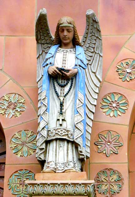 Sculpture Outside of Catholic Church of an angel holding a Rosary