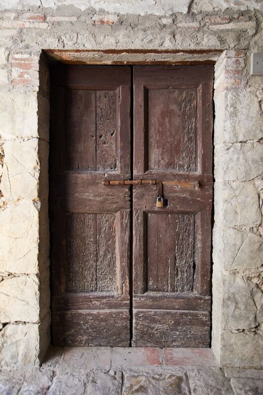 Picture of old brown door in Siena, Italy with padlock